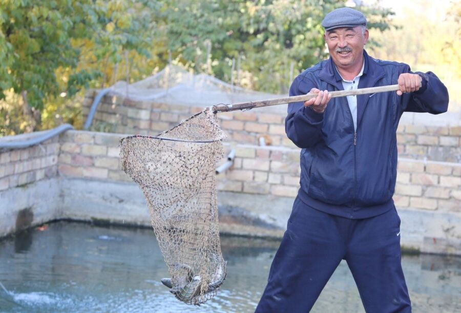 A man, Mysa Zhanchikulov, shows the fish he has caught